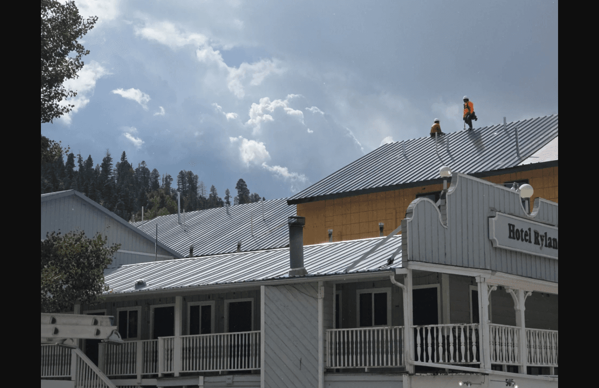 Epex roofing crew installing a standing-seam metal roof in New Mexico