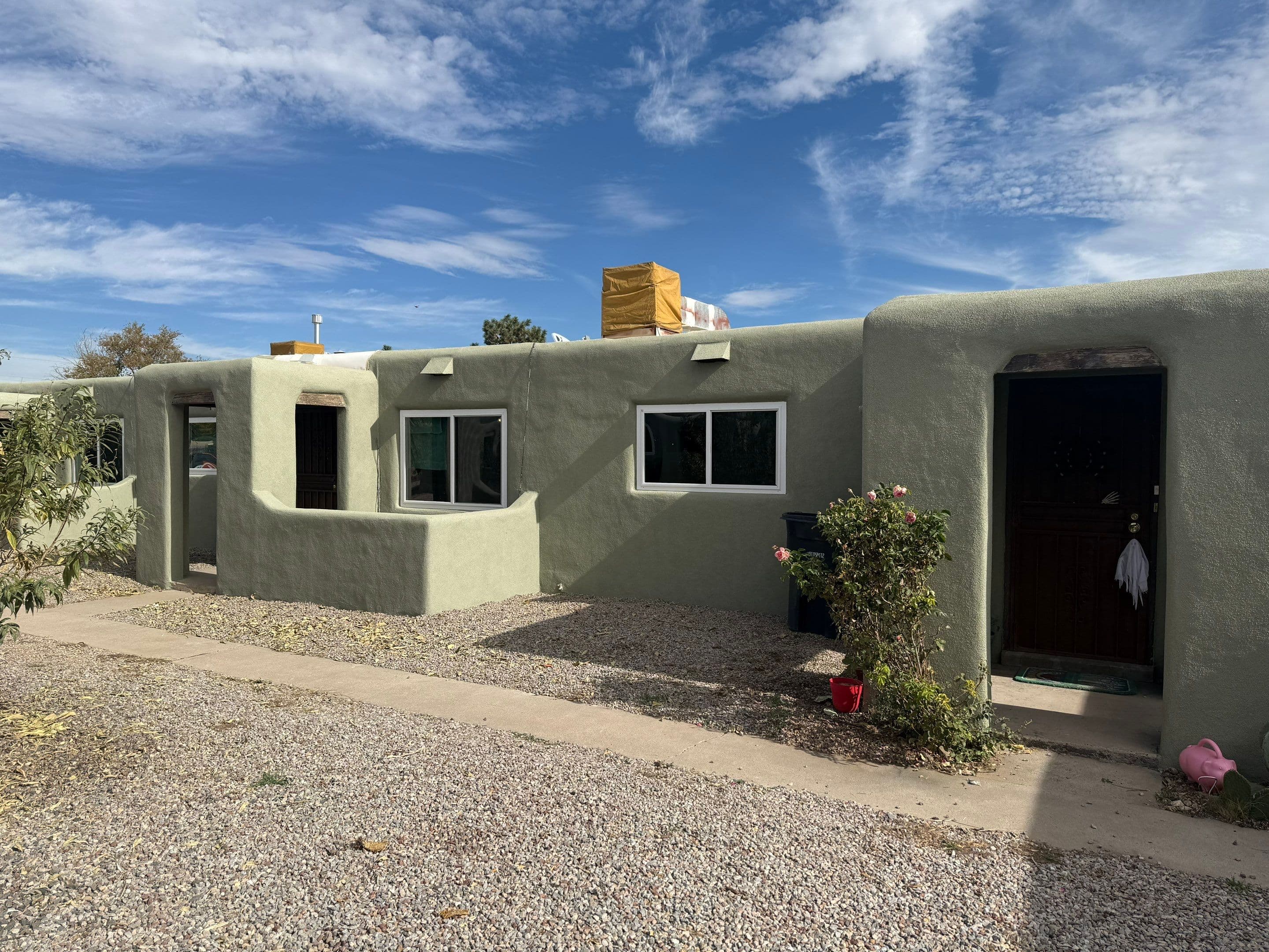 After the install — finished sage-green exterior with new Anlin replacement windows